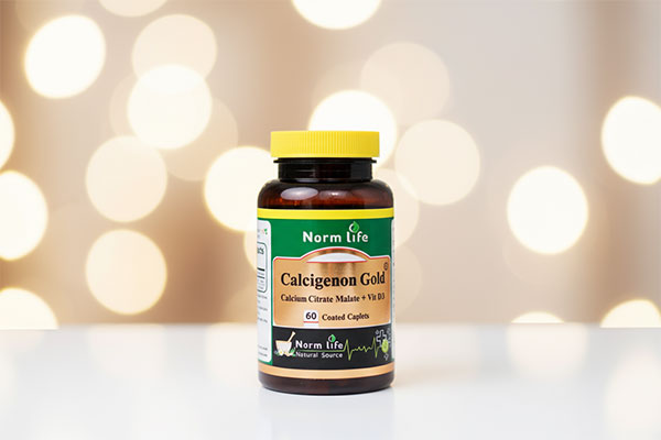 قرص روکش دار کلسی ژنون گلد نورم لایف روی سطح سفید