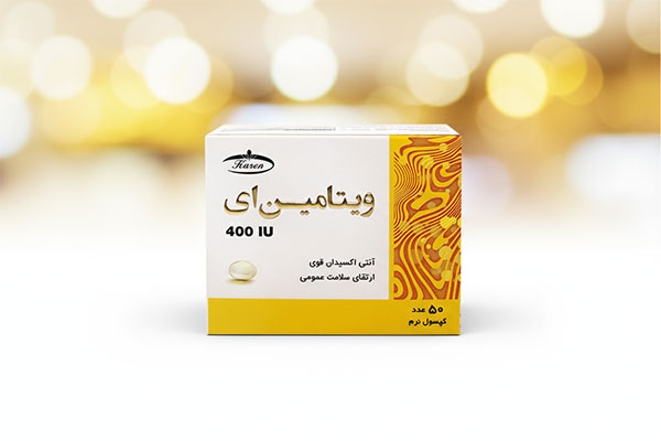 کپسول ویتامین ای 400 کارن 50 عددی روی سطح سفید
