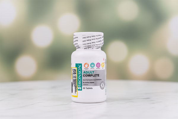 قرص ادالت کامپلیت برونسون روی سطح مرمر سفید