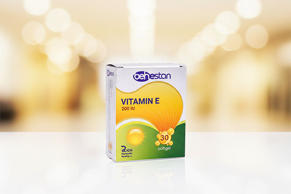 تصویر کپسول ویتامین ای 200 بهستان روی سطح سفید