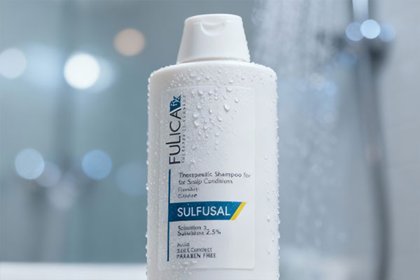 نمای نزدیک شامپو سولفوسال فولیکا با قطرات آب