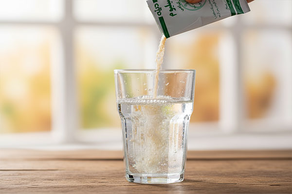 ریختن گرانول پسیلیوم دینه در لیوان آب