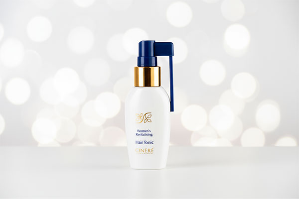 لوسیون گیاهی تقویت مو بانوان سینره روی سطح سفید