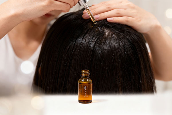 Applying hair serum for strengthening and growth