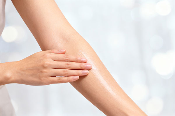 Applying moisturizing lotion on hydrated skin