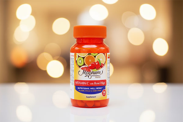بطری قرص ویتامین C رزهیپ مگنوم ویتامینز روی سطح سفید