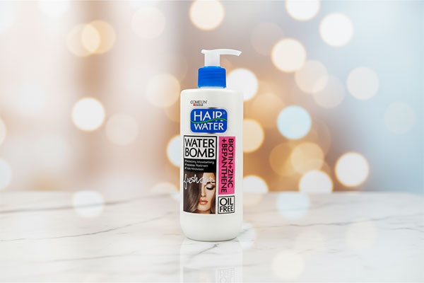 کرم آبرسان مو کامان 400 میلی لیتر روی سطح مرمر سفید