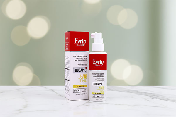 تونیک تقویت کننده مو بایوکاپیل اورین روی سطح سفید